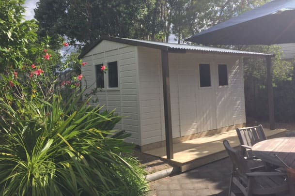 wooden garden sheds nz. A medium sized white wooden garden shed in an Auckland Back yard setting