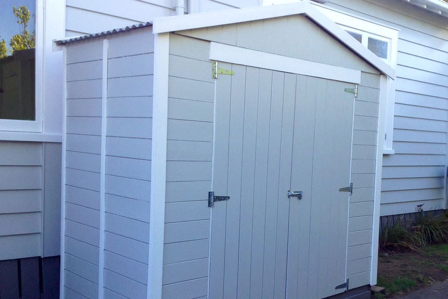 A small wooden sheds nz timber garden shed for storage up the side of a home